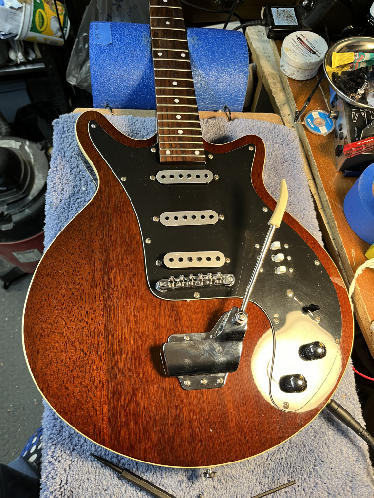 Brown special guitar with pickup covers that I spruced up with metallic vinyl, a new tremolo arm and 3 switches for pickup phase.